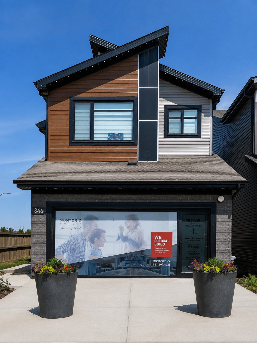Contemporary house exterior finished in wide light grey fibre cement siding with black window trim